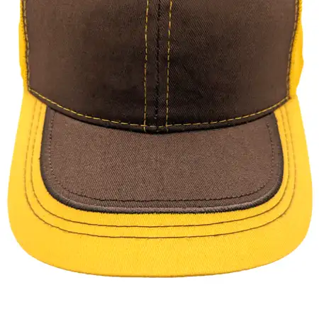 Photo of fabric applique on the upper visor of a cap, with the fabric covering a few inches of the entire edge of the visor including the front and sides